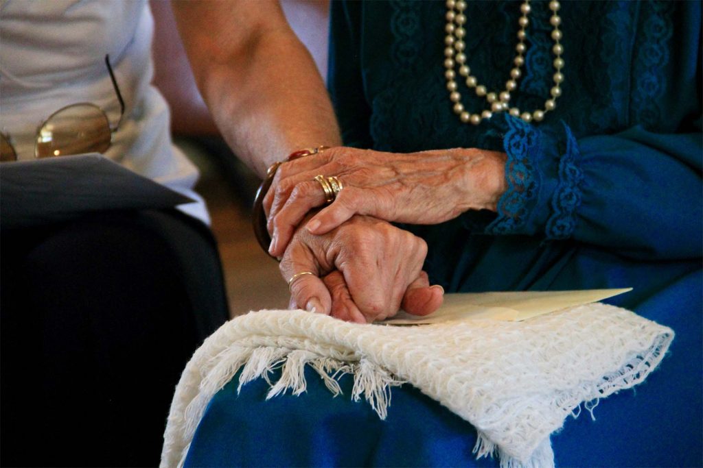 old man and lady holding hands