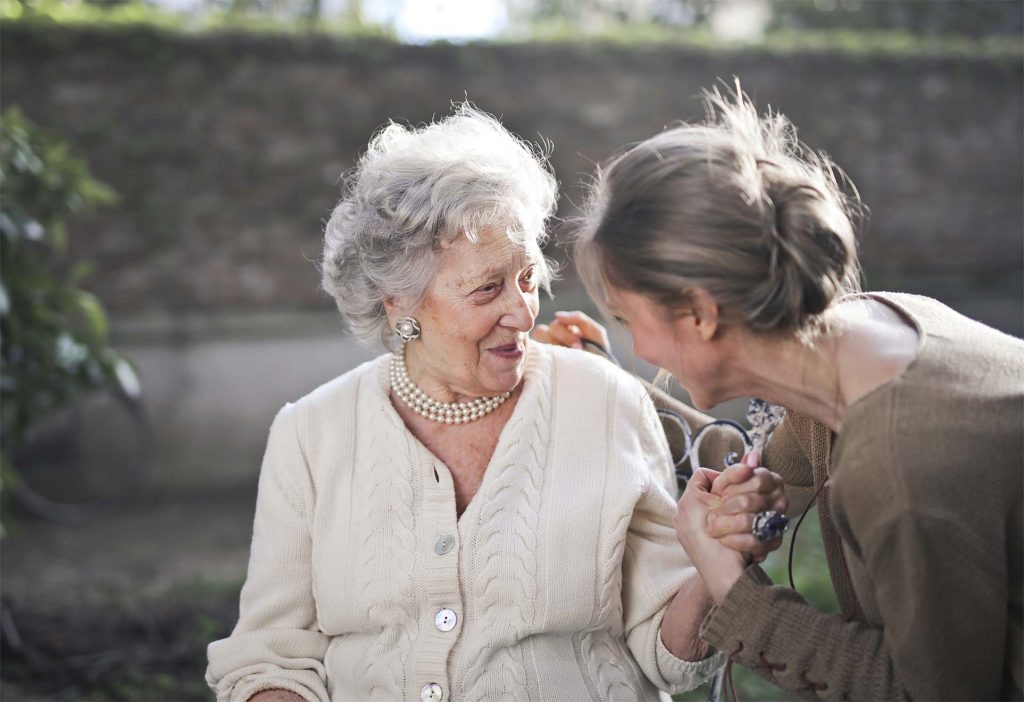 old lady chatting with a young girl