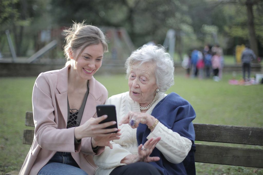 young lady helping a resident with phone